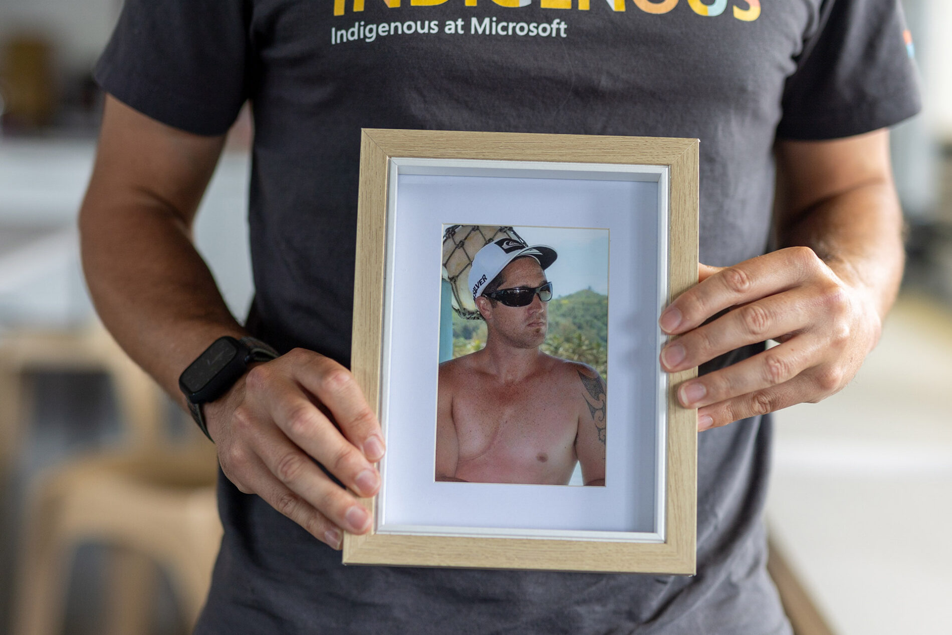 Dan holding a photo of his dad